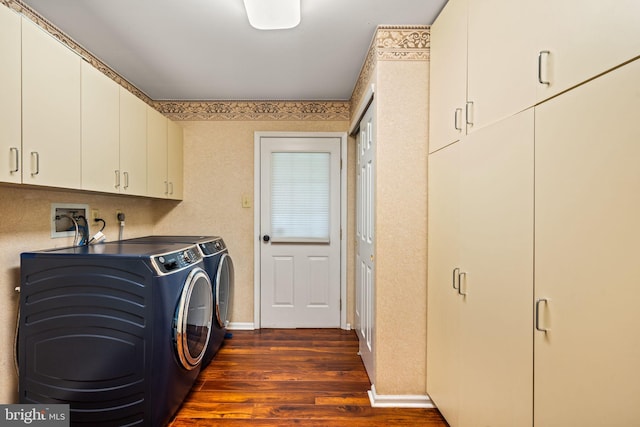 washroom with dark wood-style flooring, washing machine and dryer, cabinet space, and baseboards