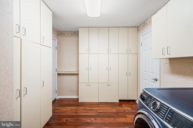 clothes washing area with cabinet space, washer / clothes dryer, and dark wood-type flooring