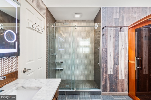 bathroom featuring a shower stall and vanity