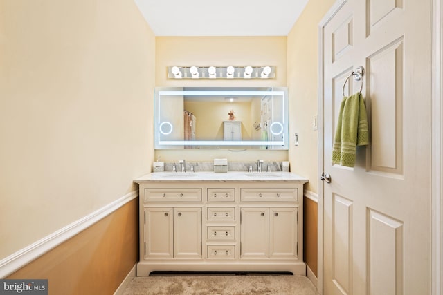 bathroom featuring double vanity and a sink