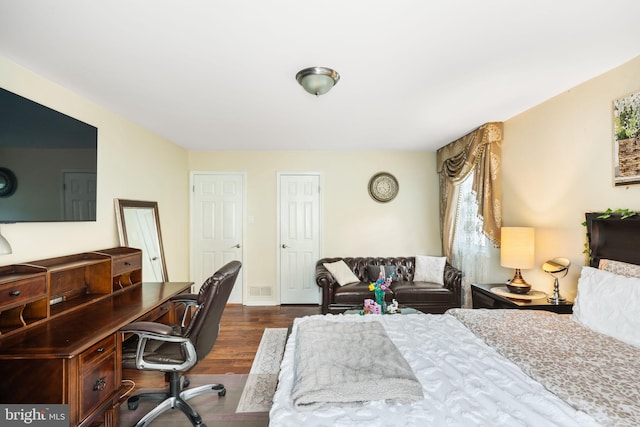 bedroom with dark wood finished floors