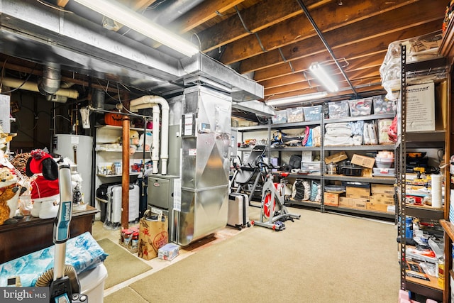 unfinished basement with gas water heater and heating unit