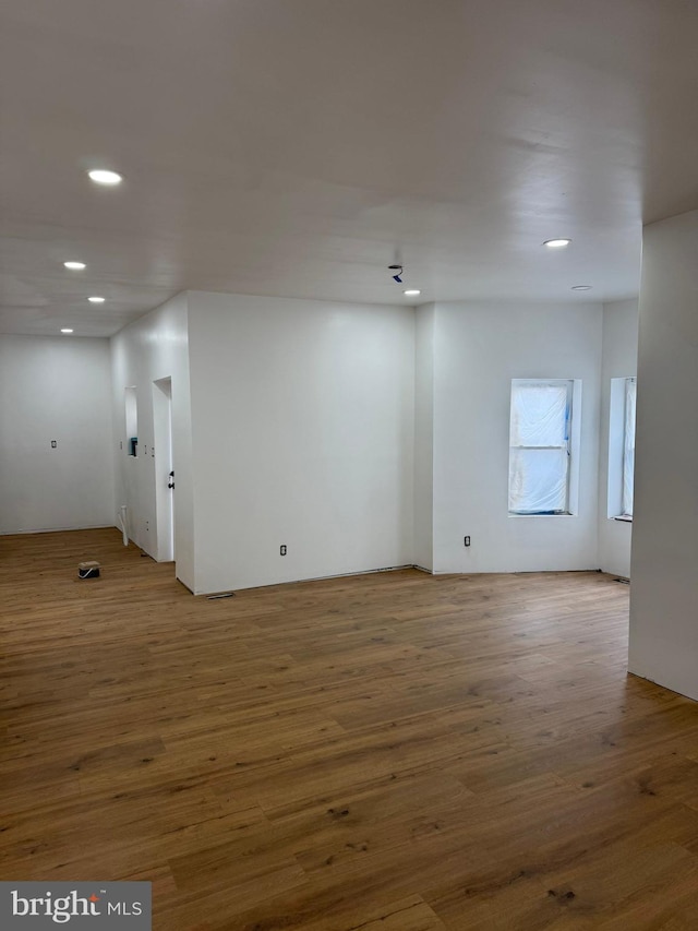 unfurnished room with wood finished floors and recessed lighting