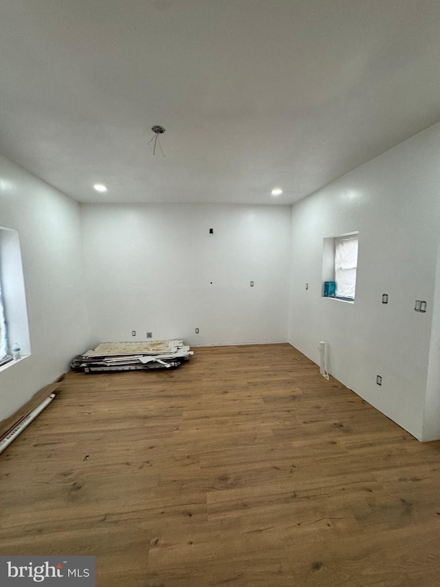 unfurnished room with wood finished floors