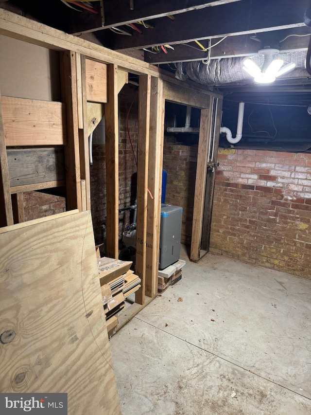 unfinished basement featuring brick wall