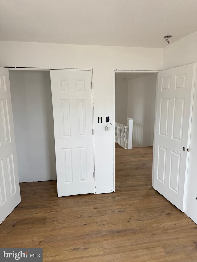 unfurnished bedroom featuring a closet and wood finished floors