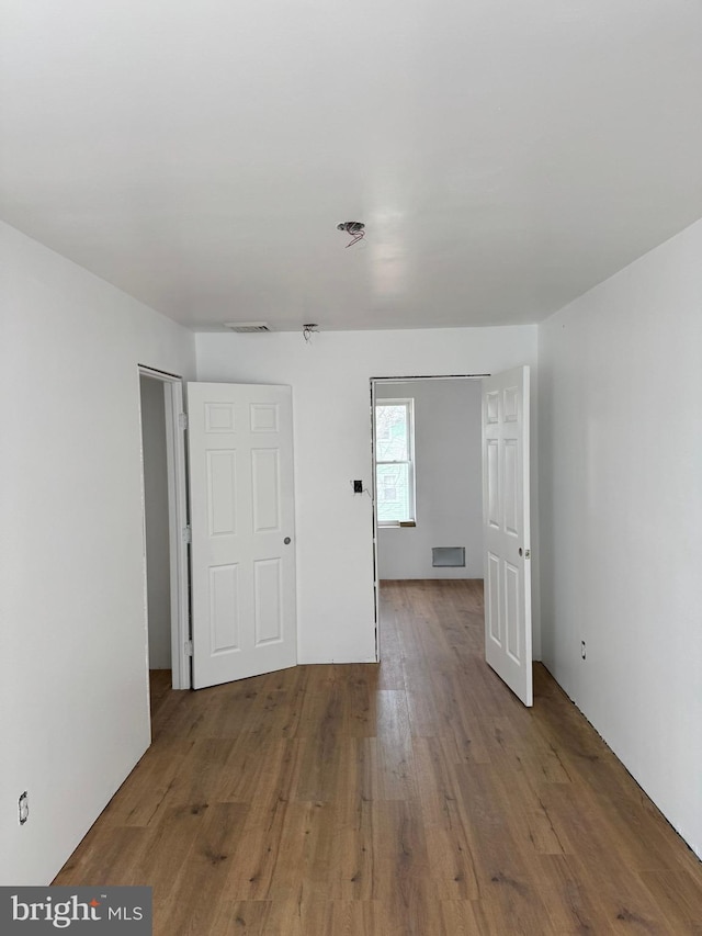 interior space featuring hardwood / wood-style floors and visible vents