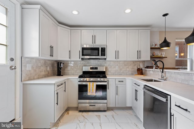 kitchen with recessed lighting, a sink, stainless steel appliances, light countertops, and marble finish floor