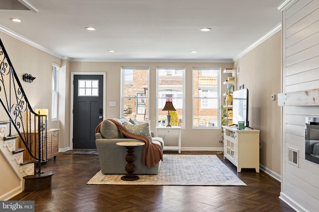 interior space with plenty of natural light, stairs, baseboards, and ornamental molding