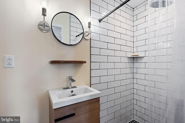 full bathroom with vanity and tiled shower