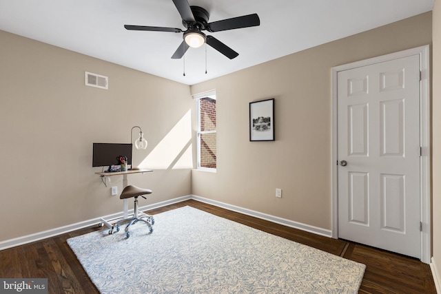 office area with visible vents, baseboards, dark wood finished floors, and a ceiling fan