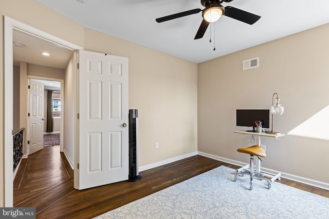 interior space featuring visible vents, baseboards, ceiling fan, and wood finished floors