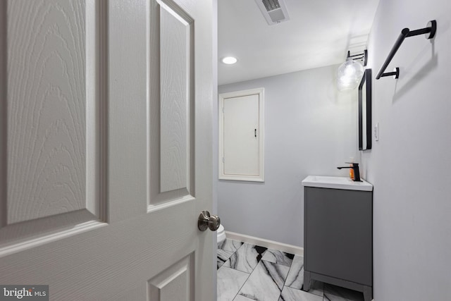 bathroom featuring visible vents, marble finish floor, recessed lighting, baseboards, and vanity