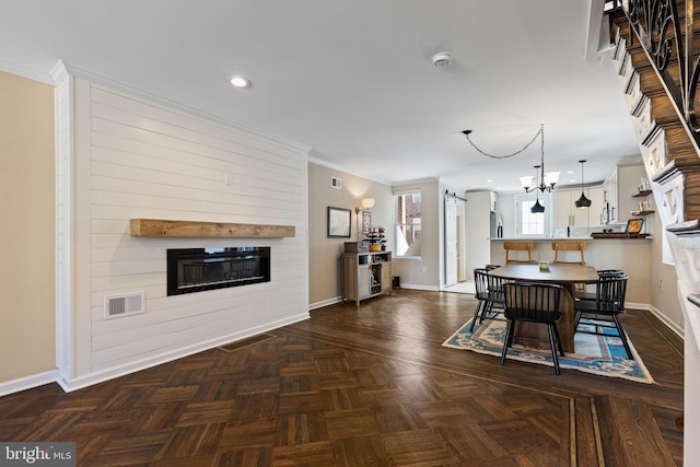 dining area with crown molding, a fireplace, visible vents, and baseboards