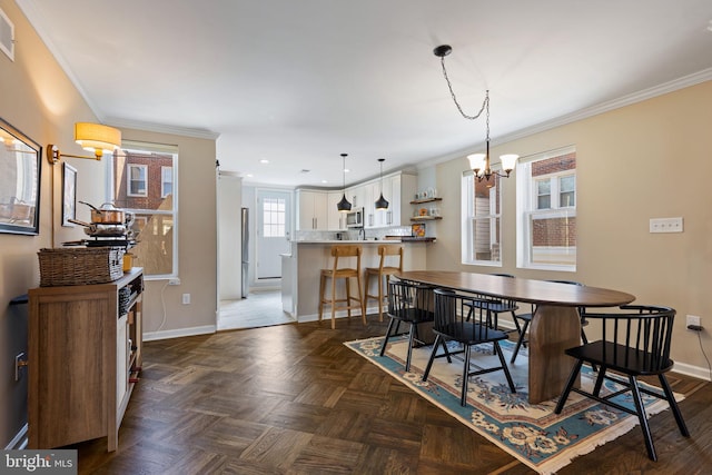 dining area featuring visible vents, baseboards, an inviting chandelier, and ornamental molding