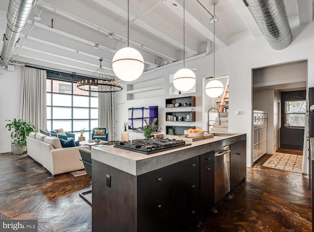 kitchen with a sink, dark cabinetry, concrete floors, stainless steel dishwasher, and black gas stovetop