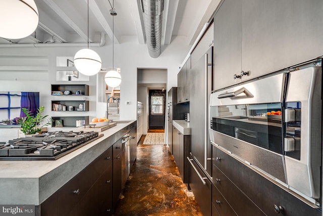 kitchen featuring light countertops, dark brown cabinets, gas stovetop, concrete floors, and a sink