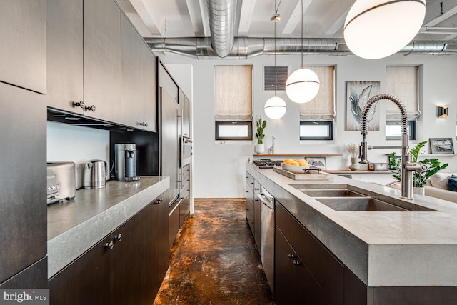 kitchen with concrete flooring, a sink, visible vents, dark brown cabinets, and a center island with sink