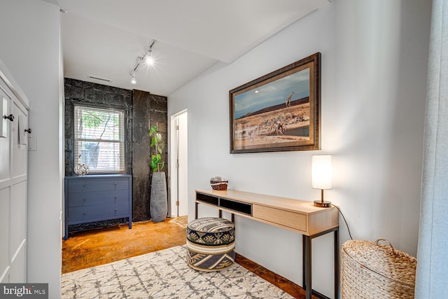 home office with concrete flooring and track lighting