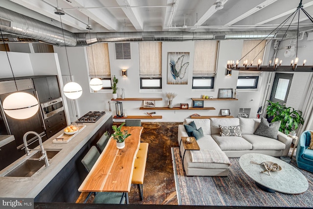 living area featuring visible vents and an inviting chandelier