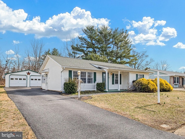 ranch-style house featuring a porch, a front yard, a garage, an outdoor structure, and driveway