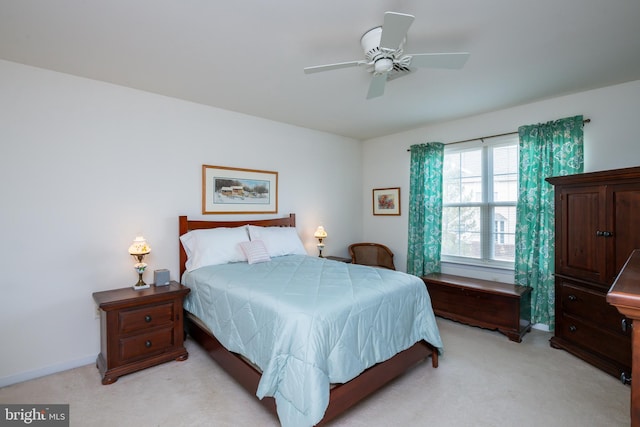 bedroom featuring baseboards, a ceiling fan, and light colored carpet