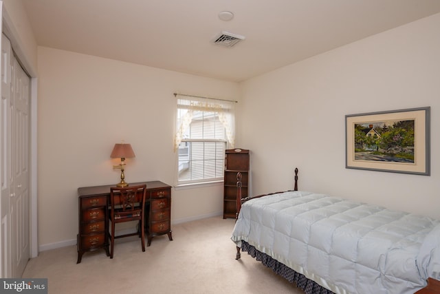 carpeted bedroom with a closet, visible vents, and baseboards