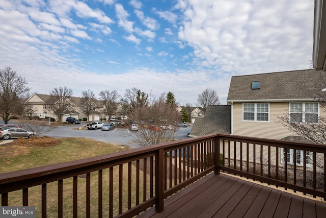 deck featuring a yard and a residential view