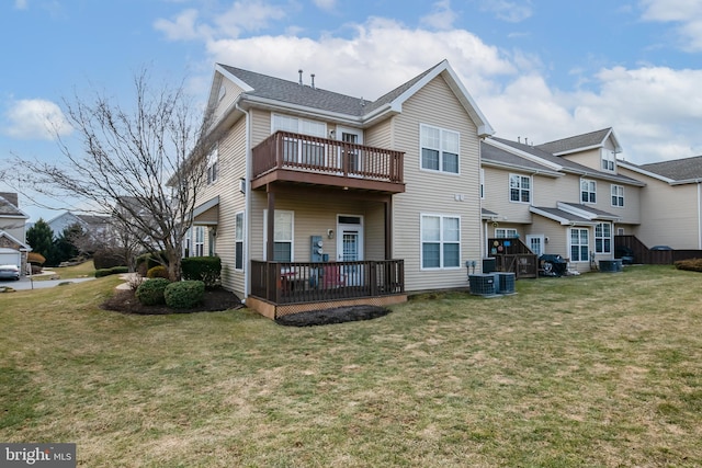 back of house with a yard and a deck