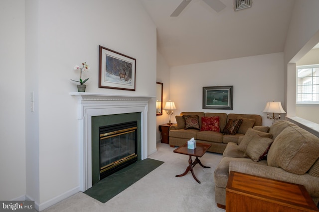 carpeted living room with visible vents, baseboards, ceiling fan, a fireplace with flush hearth, and vaulted ceiling