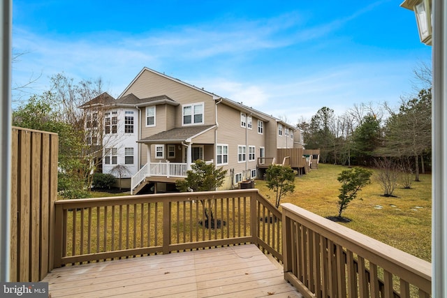 wooden deck featuring a residential view and a lawn