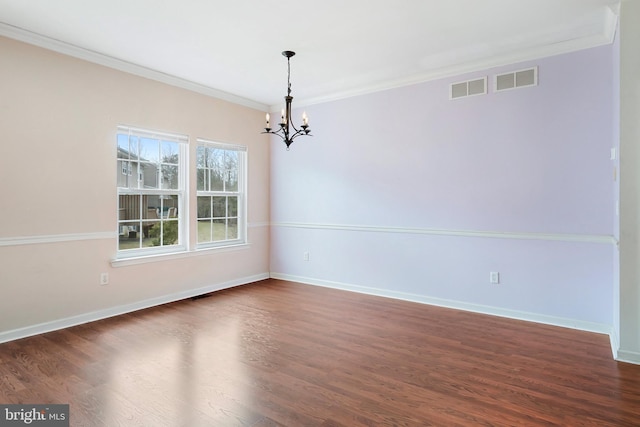 empty room featuring visible vents, dark wood-style flooring, and crown molding