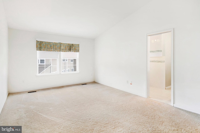 carpeted spare room featuring visible vents