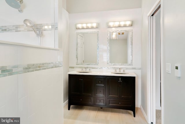 full bath with a sink and double vanity