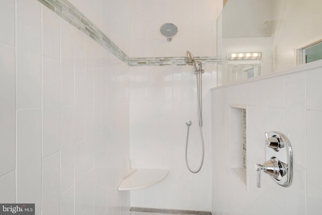 bathroom with a tile shower