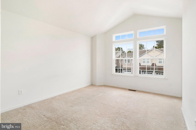 interior space featuring visible vents, baseboards, carpet, and high vaulted ceiling