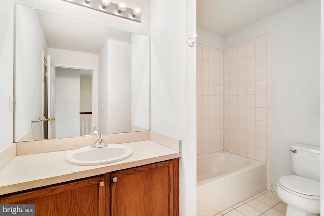 bathroom with vanity, tile patterned floors, toilet, and shower / bathtub combination