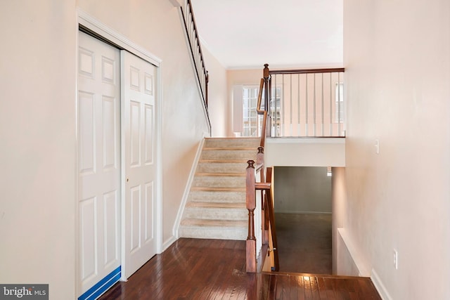 stairs with hardwood / wood-style flooring, crown molding, and baseboards