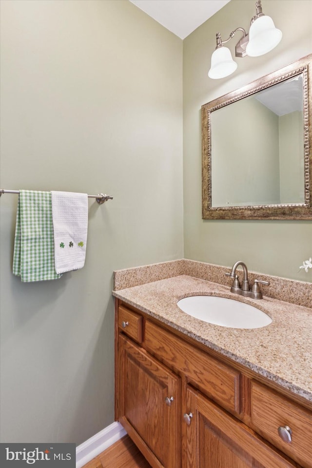 bathroom with vanity and baseboards