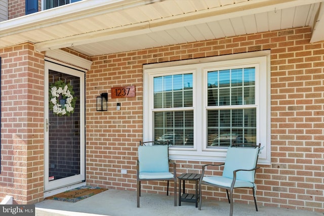 entrance to property with brick siding