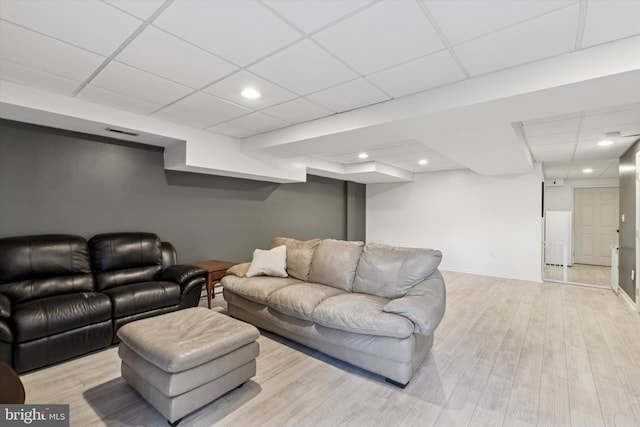 living area with a paneled ceiling, recessed lighting, wood finished floors, visible vents, and baseboards