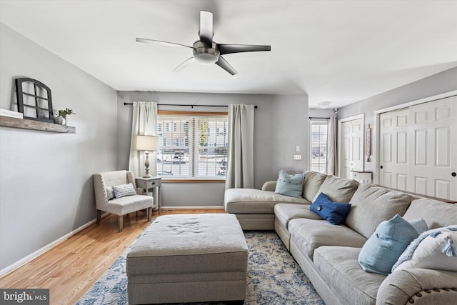 living area featuring ceiling fan, wood finished floors, and baseboards