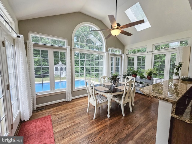 sunroom with lofted ceiling with skylight and a ceiling fan