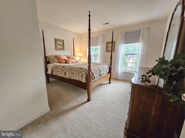 carpeted bedroom with visible vents and baseboards