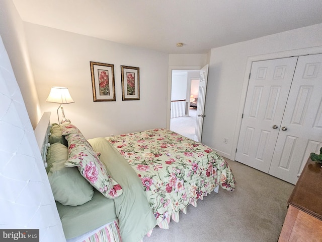 bedroom with carpet floors, a closet, and baseboards