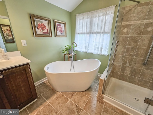 bathroom with a soaking tub, vaulted ceiling, a shower stall, and vanity