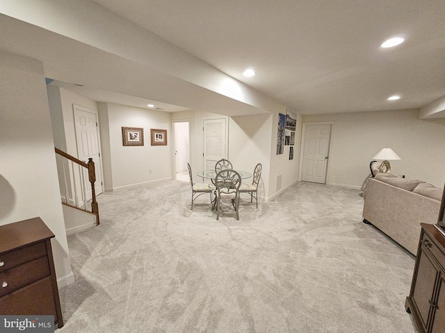 dining room with stairs, recessed lighting, and light colored carpet