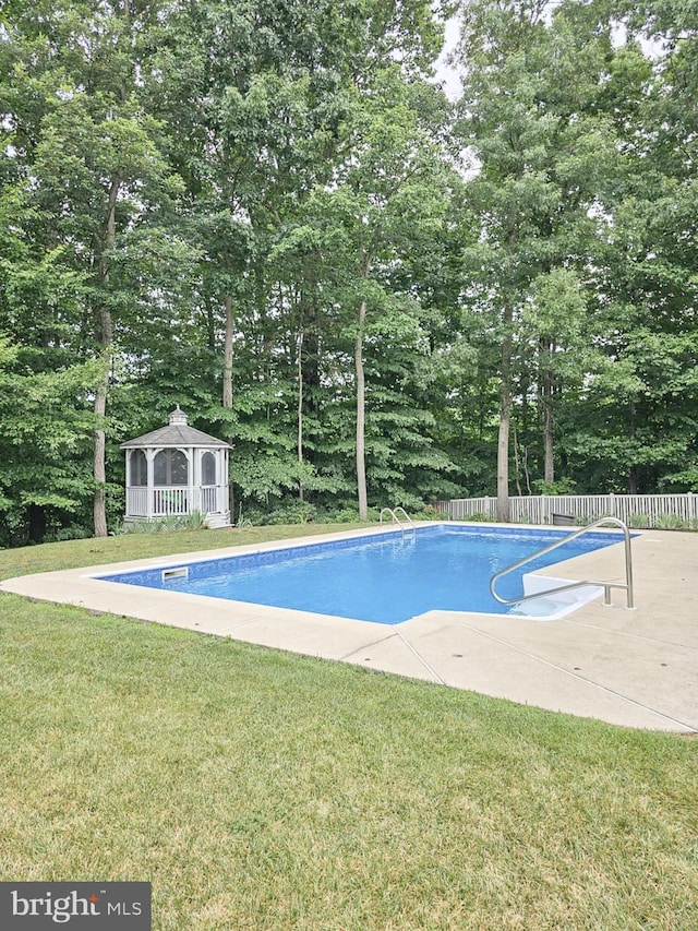 view of pool featuring a gazebo, a yard, fence, and a fenced in pool