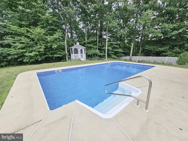 view of swimming pool with a fenced in pool, a patio, a gazebo, fence, and a yard