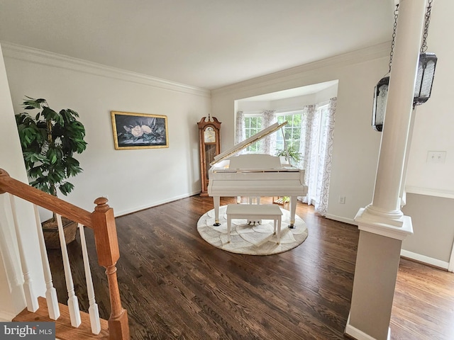 unfurnished room with ornate columns, crown molding, stairs, and wood finished floors